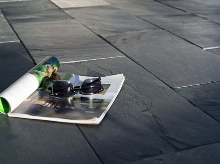 Una rivista e gli occhiali da sole sulle lavagne al sole