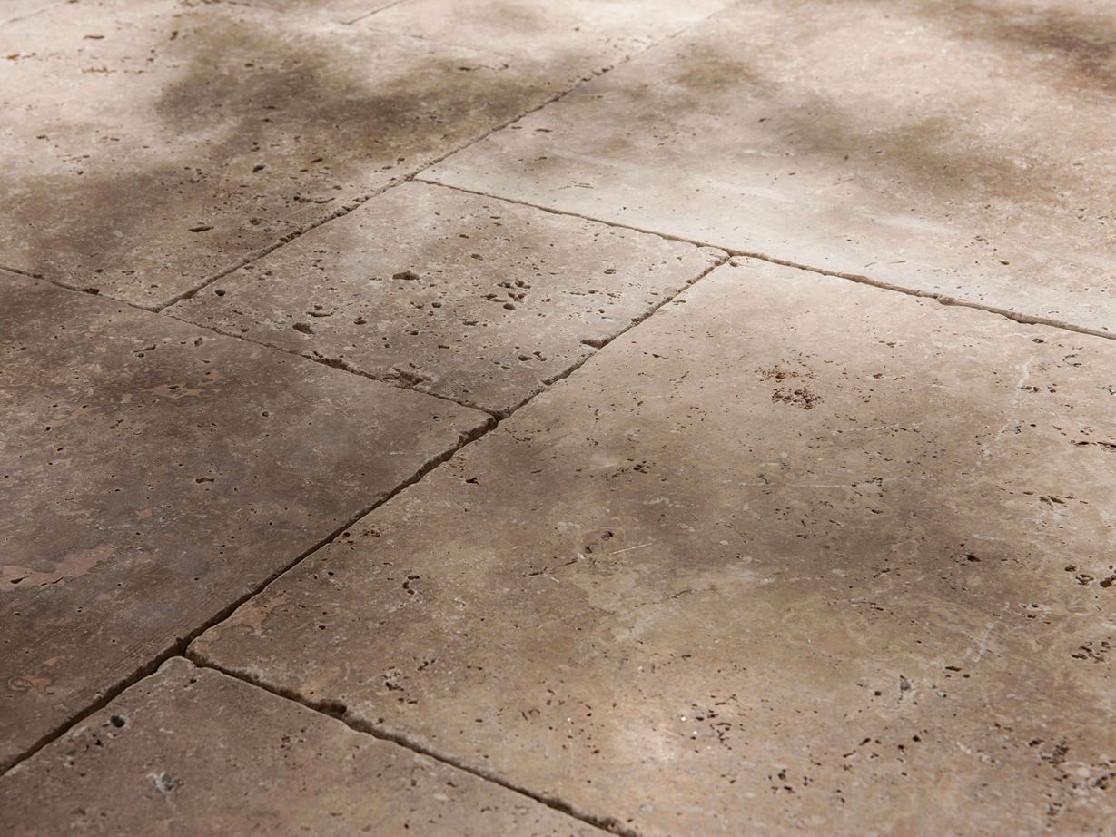 Rustico e naturale con molti pori Lastre di travertino Noce, burattato, primo piano laterale con mezz'ombra