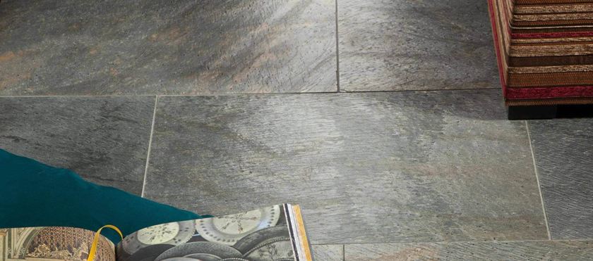 Libro e cuscino su piastrella di quarzite Deoli Green posata a secco