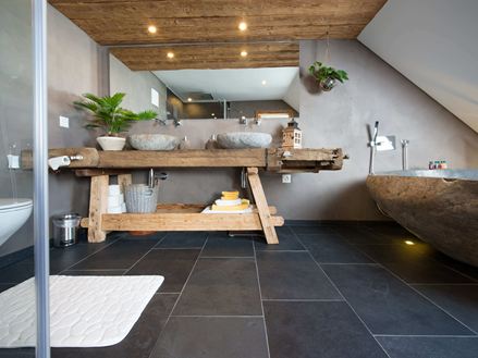 Bagno rustico con piastrelle in ardesia e mobili in legno