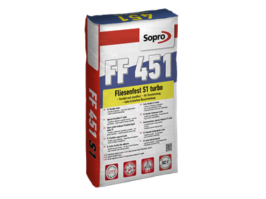 Un sacchetto di adesivo flessibile grigio per la posa di Piastrelle