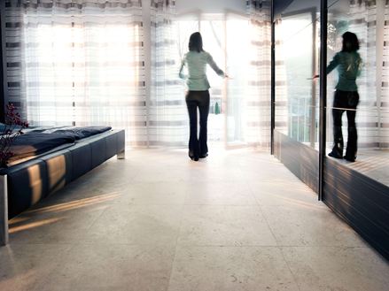 Piastrelle in travertino Medium Line con donna alla finestra