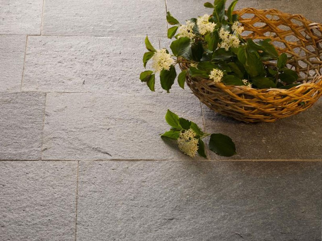 Lastre per patio in quarzite con cesto decorativo e piante